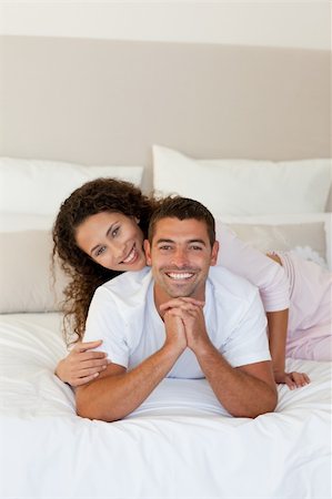 simsearch:400-05749447,k - Pretty woman hugging her husband on their bed at home Stock Photo - Budget Royalty-Free & Subscription, Code: 400-04324852