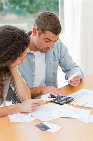 simsearch:400-05746763,k - Young couple calculating their domestic bills at home Stock Photo - Budget Royalty-Free & Subscription, Code: 400-04325200