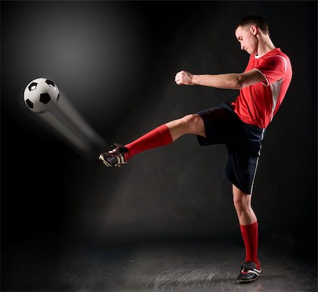 football player strongly hits the ball in dark Stock Photo - Budget Royalty-Free & Subscription, Code: 400-04325506
