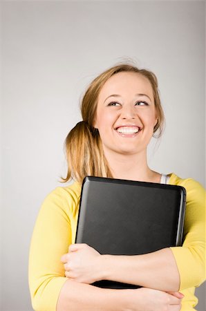 programmer (female) - young woman is holding laptop in hands Stock Photo - Budget Royalty-Free & Subscription, Code: 400-04325529