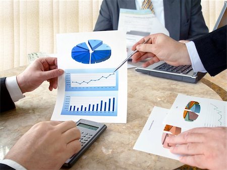 revenue - Closeup of hands with financial  charts  at business meeting in the office Stock Photo - Budget Royalty-Free & Subscription, Code: 400-04325688