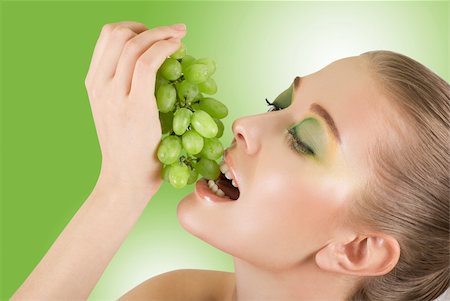 photo of model woman with grapes - Pretty young woman with grape closeup on the green background Stock Photo - Budget Royalty-Free & Subscription, Code: 400-04325770