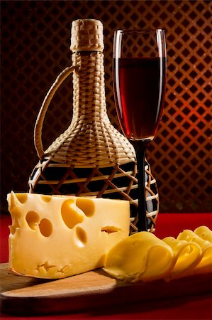 elegant wine tasting - Red wine glass, bottle and slices of cheese Stock Photo - Budget Royalty-Free & Subscription, Code: 400-04325894