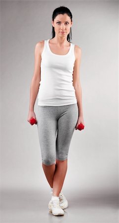 simsearch:400-04361224,k - sporty woman is standing with barbells on grey background Stock Photo - Budget Royalty-Free & Subscription, Code: 400-04325988