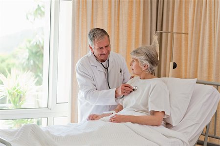 Senior doctor taking the heartbeat of his patient Stock Photo - Budget Royalty-Free & Subscription, Code: 400-04326174