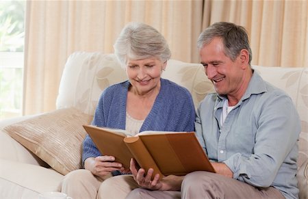 Seniors looking at their photo album at home Stock Photo - Budget Royalty-Free & Subscription, Code: 400-04326200