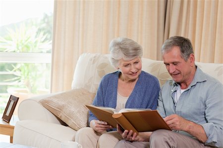 simsearch:400-04311095,k - Seniors looking at their photo album at home Stock Photo - Budget Royalty-Free & Subscription, Code: 400-04326201