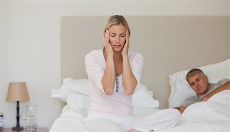 simsearch:649-03487806,k - Woman having a headache while her husband is sleeping Stock Photo - Budget Royalty-Free & Subscription, Code: 400-04326354