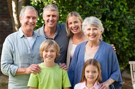 simsearch:400-06097548,k - Family looking at the camera in the garden Photographie de stock - Aubaine LD & Abonnement, Code: 400-04326365