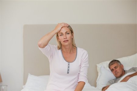 simsearch:649-03487806,k - Woman having a headache while her husband is sleeping Stock Photo - Budget Royalty-Free & Subscription, Code: 400-04326369