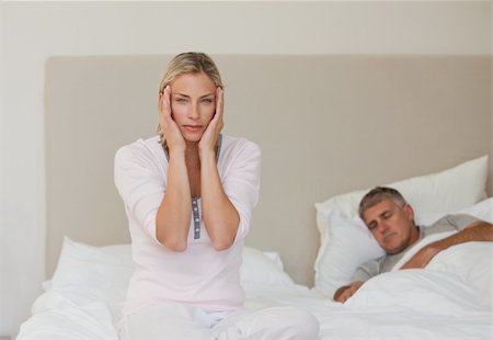 simsearch:649-03487806,k - Woman having a headache while her husband is sleeping Stock Photo - Budget Royalty-Free & Subscription, Code: 400-04326374