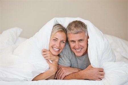 simsearch:400-05749447,k - Couple lying down in their bed at home Stock Photo - Budget Royalty-Free & Subscription, Code: 400-04326377