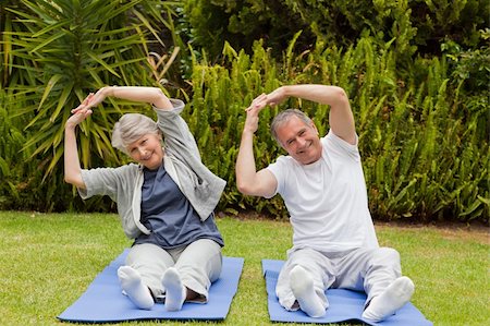 Senior couple doing their streches in the garden Stock Photo - Budget Royalty-Free & Subscription, Code: 400-04326526