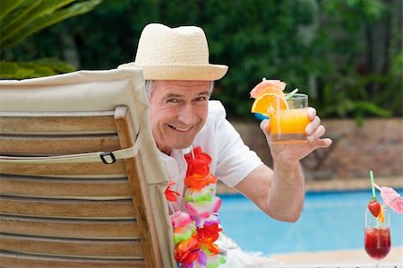 pool and cruise ship - Mature man drinking a cocktail  beside the swimming pool Stock Photo - Budget Royalty-Free & Subscription, Code: 400-04326545