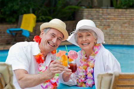 Happy senior couple drinking cocktail and toasting each other Stock Photo - Budget Royalty-Free & Subscription, Code: 400-04326556