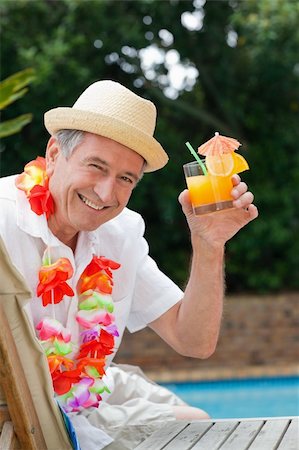 pool and cruise ship - Mature man drinking a cocktail  beside the swimming pool Stock Photo - Budget Royalty-Free & Subscription, Code: 400-04326550