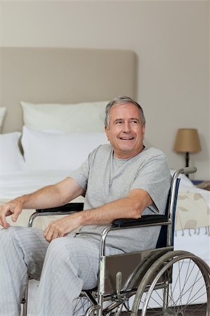 Smiling senior man in his wheelchair  at home Stock Photo - Budget Royalty-Free & Subscription, Code: 400-04326643