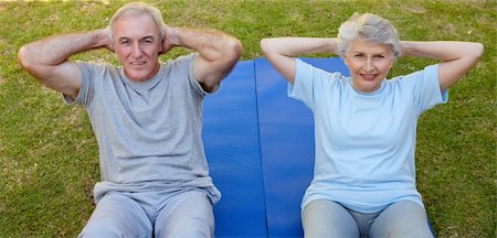 Retired couple doing their streches in the garden Stock Photo - Budget Royalty-Free & Subscription, Code: 400-04326777