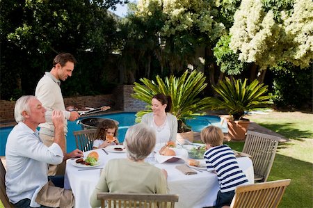 simsearch:400-04327229,k - Family eating in the garden Stock Photo - Budget Royalty-Free & Subscription, Code: 400-04326779