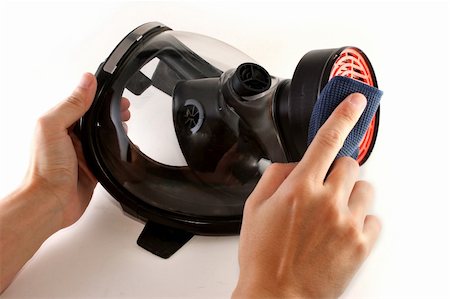 simsearch:400-08077627,k - Hands cleaning a black gas mask with a piece of blue cloth Stock Photo - Budget Royalty-Free & Subscription, Code: 400-04327012