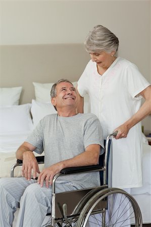 Retired man in his wheelchair with his wife Stock Photo - Budget Royalty-Free & Subscription, Code: 400-04327067