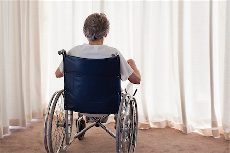 simsearch:400-04327098,k - Mature woman in her wheelchair with her back to the camera at home Stock Photo - Budget Royalty-Free & Subscription, Code: 400-04327092