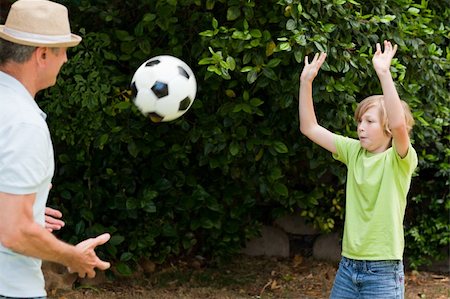 Grandfather and his grandson playing football Stock Photo - Budget Royalty-Free & Subscription, Code: 400-04327125
