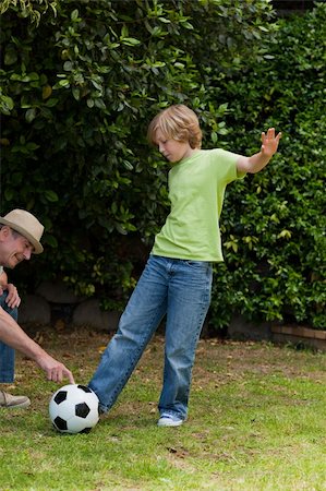 Grandfather and his grandson playing football Stock Photo - Budget Royalty-Free & Subscription, Code: 400-04327127