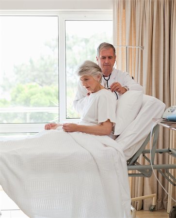 Senior doctor taking the heartbeat of his patient Stock Photo - Budget Royalty-Free & Subscription, Code: 400-04327145