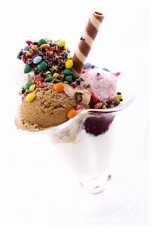 Ice cream dessert with colorful candies on white background Stock Photo - Budget Royalty-Free & Subscription, Code: 400-04327165
