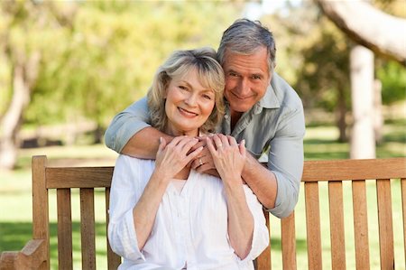 Elderly man hugging his wife who is on the bench Stock Photo - Budget Royalty-Free & Subscription, Code: 400-04327747