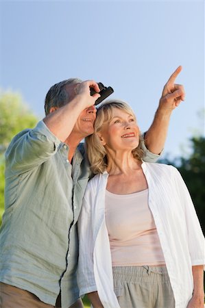 side portrait view older people - Couple looking at the sky with their binoculars Stock Photo - Budget Royalty-Free & Subscription, Code: 400-04327765