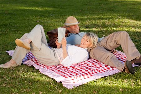 simsearch:400-04522125,k - Woman reading while her husband is sleeping in the park Stock Photo - Budget Royalty-Free & Subscription, Code: 400-04327769