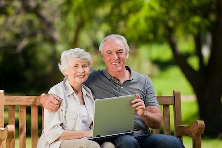 Elderly couple looking at their laptop Stock Photo - Budget Royalty-Free & Subscription, Code: 400-04327775