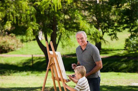Grandfather and his grandson painting in the garden Stock Photo - Budget Royalty-Free & Subscription, Code: 400-04327773