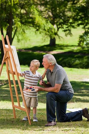 Grandfather and his grandson painting in the garden Stock Photo - Budget Royalty-Free & Subscription, Code: 400-04327784