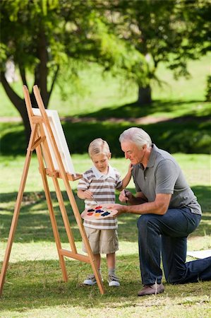 Grandfather and his grandson painting in the garden Stock Photo - Budget Royalty-Free & Subscription, Code: 400-04327789