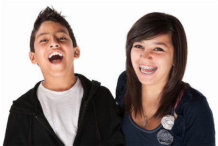 Two hispanic kids laughing on white background Foto de stock - Super Valor sin royalties y Suscripción, Código: 400-04328003