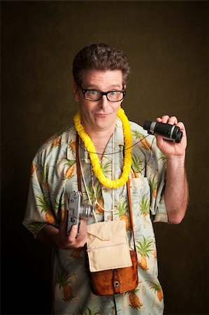 person in hawaiian shirt - Male tourist in a tropical island outfit holding a camera and binoculars Stock Photo - Budget Royalty-Free & Subscription, Code: 400-04328057