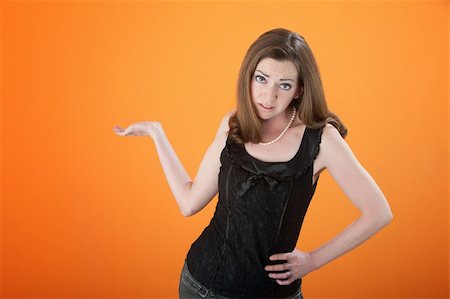 rimborso - Annoyed lady with hand on hip on orange background Fotografie stock - Microstock e Abbonamento, Codice: 400-04328123