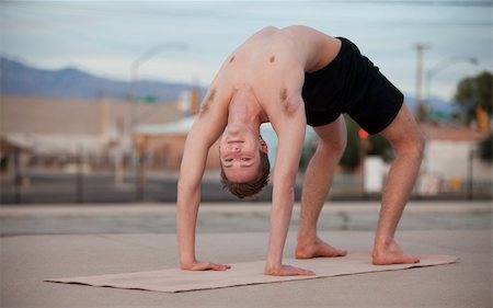 simsearch:400-04328141,k - Fit young man in Urdhva Dhanurasana yoga posture Stock Photo - Budget Royalty-Free & Subscription, Code: 400-04328141