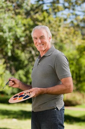 Mature man painting in the garden Stock Photo - Budget Royalty-Free & Subscription, Code: 400-04328345