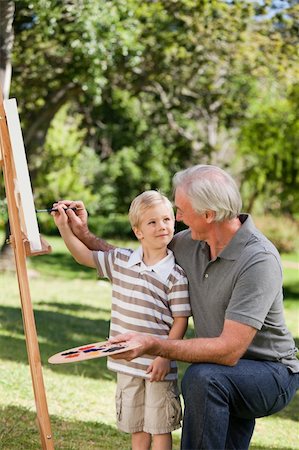 Happy Grandfather and his grandson painting in the garden Stock Photo - Budget Royalty-Free & Subscription, Code: 400-04328364