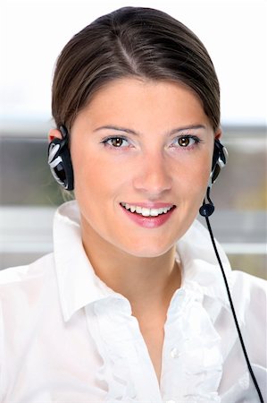 A portrait of a pretty girl in the call center over light background Stock Photo - Budget Royalty-Free & Subscription, Code: 400-04328380