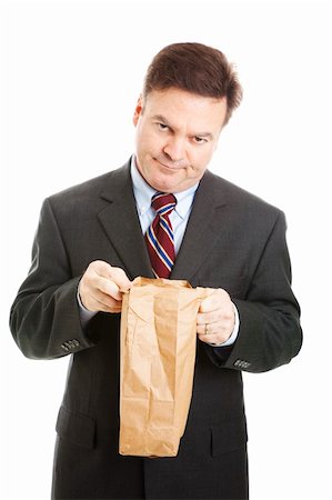 simsearch:400-05347520,k - Disappointed businessman having to bring his lunch in a bag to save money.  Isolated. Photographie de stock - Aubaine LD & Abonnement, Code: 400-04328904