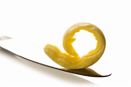 Curl of butter on knife tip on white background Fotografie stock - Microstock e Abbonamento, Codice: 400-04329444