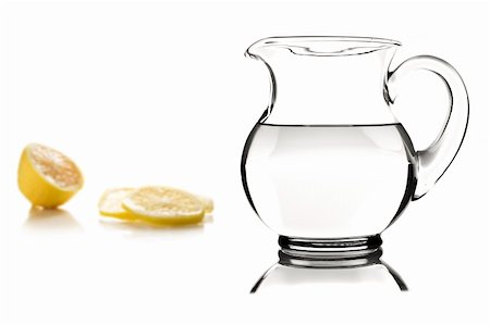 simsearch:630-02220372,k - Glass pitcher with water and lemon slices on white Foto de stock - Super Valor sin royalties y Suscripción, Código: 400-04329441