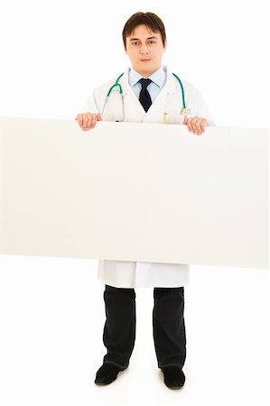 simsearch:400-05745246,k - Serious medical doctor holding blank billboard isolated on white Photographie de stock - Aubaine LD & Abonnement, Code: 400-04329653