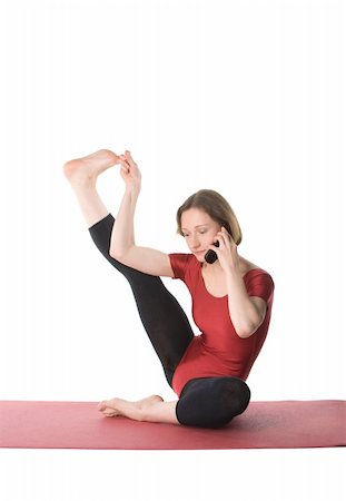 Exercising woman talking on cellphone, studio shot Stock Photo - Budget Royalty-Free & Subscription, Code: 400-04320784
