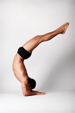 Young male dancer posing over grey background. Stock Photo - Budget Royalty-Free & Subscription, Code: 400-04320842